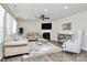 Bright living room with fireplace, ceiling fan, neutral paint, neutral-colored furniture and mirrored accents at 902 Silverberry St, Gastonia, NC 28054
