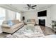 Bright living room with fireplace, ceiling fan, neutral paint, and neutral-colored contemporary furniture at 902 Silverberry St, Gastonia, NC 28054