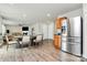 This open concept area features a stainless steel refrigerator and views into the living room at 902 Silverberry St, Gastonia, NC 28054