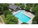 Aerial view of sparkling community pool with lounge chairs and an adjacent clubhouse, perfect for summer relaxation at 902 Silverberry St, Gastonia, NC 28054