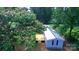 Aerial view of home featuring a metal roof, surrounded by trees, with a charming wood deck attached at , Salisbury, NC 28146