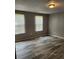 Bedroom featuring modern wood-look floors, two windows that bring in lots of light and neutral paint at , Salisbury, NC 28146