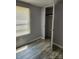 Neutral-painted bedroom with vinyl wood-look flooring, window with blinds, and a closet at , Salisbury, NC 28146