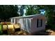 The home has a metal roof, vinyl siding, and black shutters, and features a wood deck on the side of the home at , Salisbury, NC 28146