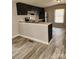 A modern kitchen with stainless steel appliances and dark wood cabinets offering a stylish and functional cooking space at , Salisbury, NC 28146