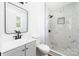 Bathroom features a modern vanity, toilet, and a walk-in shower with marble tile at 104 Spargo St, Gastonia, NC 28056