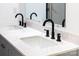 Double sinks enhance this bathroom with white marble countertops and black modern fixtures at 104 Spargo St, Gastonia, NC 28056