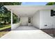 Spacious car port with white brick walls and concrete floors, provides ample covered parking at 104 Spargo St, Gastonia, NC 28056