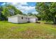 Side exterior view of the home showcasing a painted white brick with green grass at 104 Spargo St, Gastonia, NC 28056