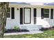 Home's entryway featuring a white door, black shutters, landscaping, and a freshly painted walkway at 104 Spargo St, Gastonia, NC 28056