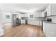 Expansive kitchen with stainless appliances, white cabinets, granite counters, and tile backsplash at 104 Spargo St, Gastonia, NC 28056