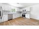 Bright kitchen featuring white cabinets, stainless steel appliances, and a gray tile backsplash at 104 Spargo St, Gastonia, NC 28056