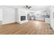 An open floor plan featuring a fireplace, white cabinets, and luxury vinyl plank flooring at 104 Spargo St, Gastonia, NC 28056