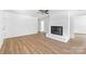 Open-concept living room featuring a painted brick fireplace and modern flooring at 104 Spargo St, Gastonia, NC 28056