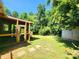 Backyard featuring the screen porch, shed and wooded areas at 125 Circle Dr, Mount Holly, NC 28120