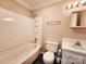 Bathroom featuring a shower-tub combo, standard toilet, and single vanity at 125 Circle Dr, Mount Holly, NC 28120