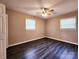 A spacious bedroom with two windows, wood-look floors and a ceiling fan at 125 Circle Dr, Mount Holly, NC 28120