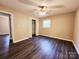 Spacious bedroom featuring updated floors, neutral paint, and closet space at 125 Circle Dr, Mount Holly, NC 28120