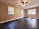 Spacious bedroom featuring neutral walls, ceiling fan, and ample natural light from multiple windows at 125 Circle Dr, Mount Holly, NC 28120