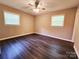 Bedroom with neutral walls, ceiling fan, and natural lighting from two windows at 125 Circle Dr, Mount Holly, NC 28120