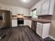 Well-lit kitchen features stainless steel appliances, stylish counters, and ample white cabinetry at 125 Circle Dr, Mount Holly, NC 28120