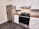 Kitchen showcasing stainless steel appliances, white cabinets, and hard surface countertops at 125 Circle Dr, Mount Holly, NC 28120