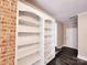 Living room displaying white built-in shelves and a brick accent wall feature at 125 Circle Dr, Mount Holly, NC 28120