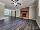Spacious living room with a brick fireplace, ceiling fan and hardwood floors at 125 Circle Dr, Mount Holly, NC 28120