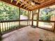 A screened porch with a wooden beam ceiling and view of trees at 125 Circle Dr, Mount Holly, NC 28120
