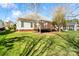 Backyard featuring a deck with a lush lawn and mature trees, creating a private oasis at 1730 Townsend Ln, Rock Hill, SC 29730