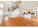 Bright living room featuring hardwood floors, staircase, high ceilings and an open floor plan to the kitchen at 1730 Townsend Ln, Rock Hill, SC 29730