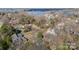 Aerial view of community surrounded by tall trees with multiple houses and waterfront views at 20016 Walter Henderson Rd, Cornelius, NC 28031