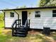 Exterior of a white home with a black door, black trim, and a black entrance platform with stairs at 20016 Walter Henderson Rd, Cornelius, NC 28031