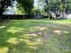 Large grassy backyard area with trees and a privacy fence and a small structure in the distance at 20016 Walter Henderson Rd, Cornelius, NC 28031
