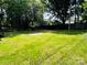 A green lawn with a concrete slab in the middle, surrounded by trees and a fence in the background at 20016 Walter Henderson Rd, Cornelius, NC 28031