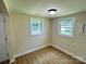 Cozy bedroom with ample natural light provided by two windows and new flooring at 20016 Walter Henderson Rd, Cornelius, NC 28031