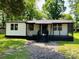 Inviting home with a screened-in porch and well-manicured lawn at 20016 Walter Henderson Rd, Cornelius, NC 28031