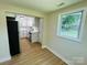 Modern kitchen boasts white cabinets, stainless steel appliances, and wood flooring providing a sleek design at 20016 Walter Henderson Rd, Cornelius, NC 28031