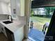 Modern kitchen featuring white cabinets, quartz countertops, stainless appliances, and backyard access at 20016 Walter Henderson Rd, Cornelius, NC 28031