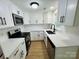 Updated kitchen features white cabinetry, quartz countertops, stainless appliances, and new fixtures at 20016 Walter Henderson Rd, Cornelius, NC 28031
