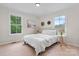 Bright bedroom with hardwood floors, white walls, two windows, and a comfortable bed at 2704 Kool Park Ne Rd, Hickory, NC 28601