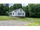 A cozy white house with a charming porch and stairs leading to the entrance at 2704 Kool Park Ne Rd, Hickory, NC 28601