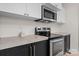 Modern kitchen featuring stainless steel appliances and black hardware set against white walls and stylish decor at 2704 Kool Park Ne Rd, Hickory, NC 28601