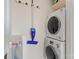 Small laundry room with stacked washer and dryer and hanging rack at 2704 Kool Park Ne Rd, Hickory, NC 28601