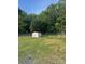 View of a fenced backyard with grass and a shed, providing secure outdoor space at 3085 Faith Rd, Salisbury, NC 28146