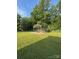 Lush backyard with a metal awning structure, ideal for outdoor projects or parking at 3085 Faith Rd, Salisbury, NC 28146