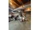 Unfinished basement with exposed ducts, brick accent wall, and shelving at 3085 Faith Rd, Salisbury, NC 28146