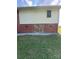 Exterior side view of brick home with lower level access to the yard at 3085 Faith Rd, Salisbury, NC 28146