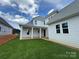 A beautifully landscaped backyard featuring a covered patio with white columns on a sunny day at 4528 Splash Trl # 195, Sherrills Ford, NC 28673