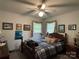 Modest bedroom features a ceiling fan, traditional furnishings, and decorative accents at 506 Hearne Farm Rd, Mount Gilead, NC 27306